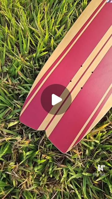 64" fish tail board on grass — red and wood stripe